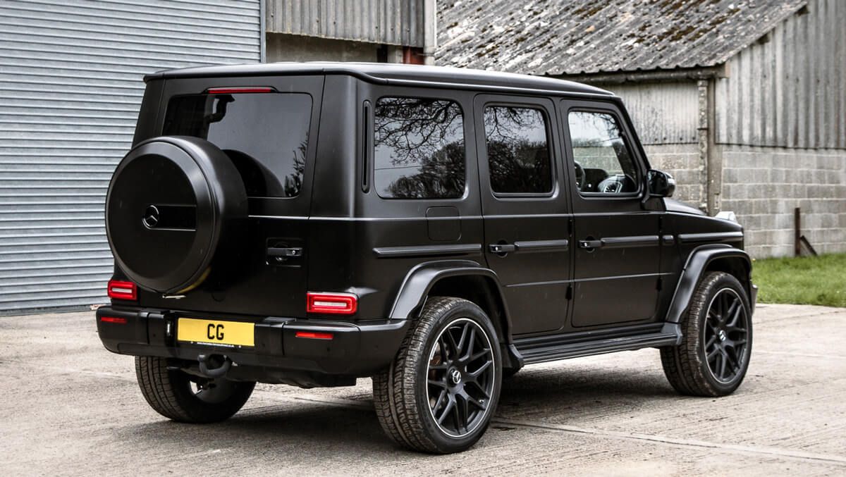 A Mercedes G-Class SUV parked in front of a rustic barn, showcasing its sleek design against a rural backdrop. A Mercedes G-Class SUV parked in front of a rustic barn, showcasing its sleek design against a rural backdrop.