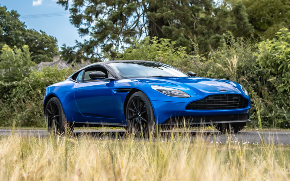 A luxury car (Aston Martin) wrapped in blue
