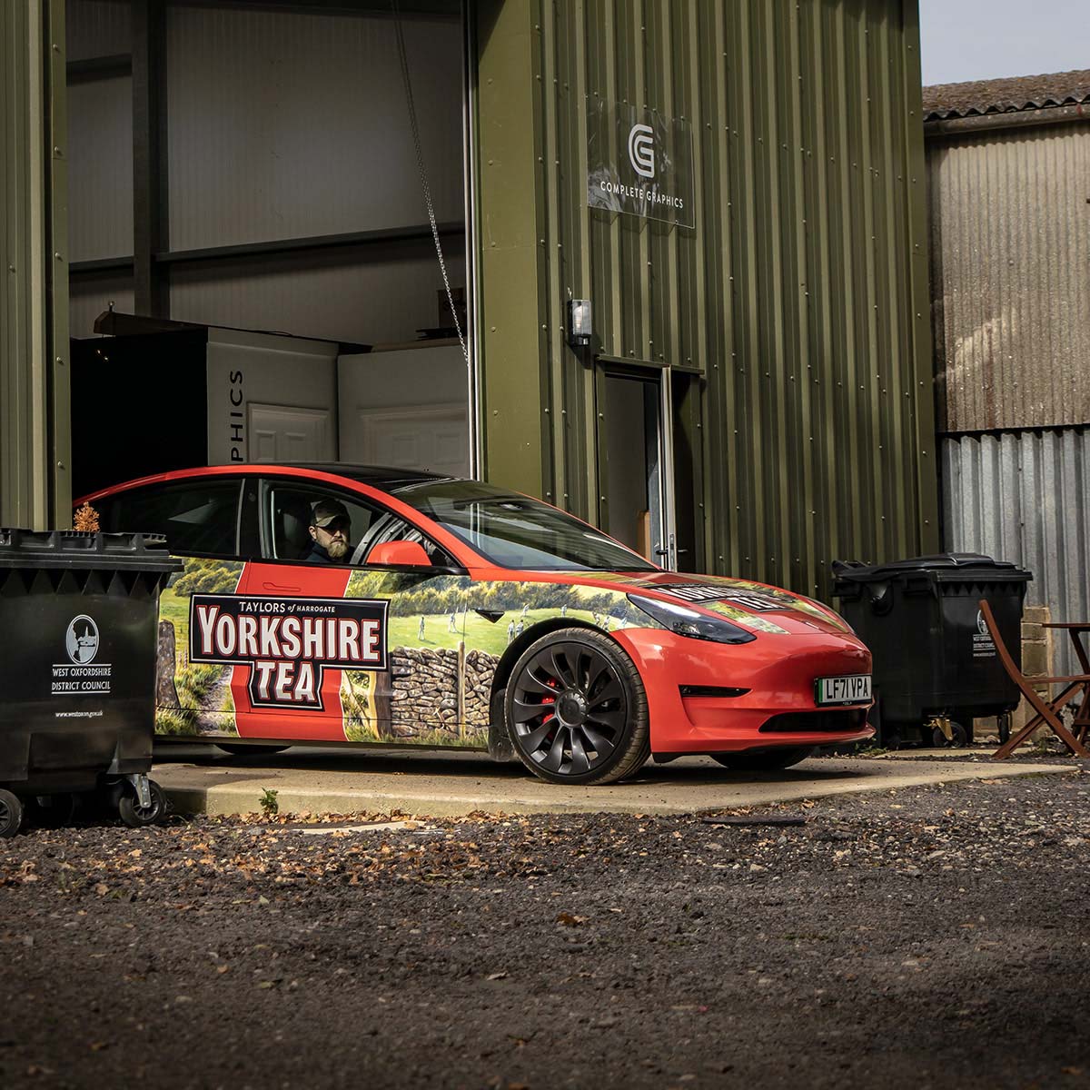 Yorkshire Tea branded Tesla Model 3 parked outside the Complete Graphics workshop.