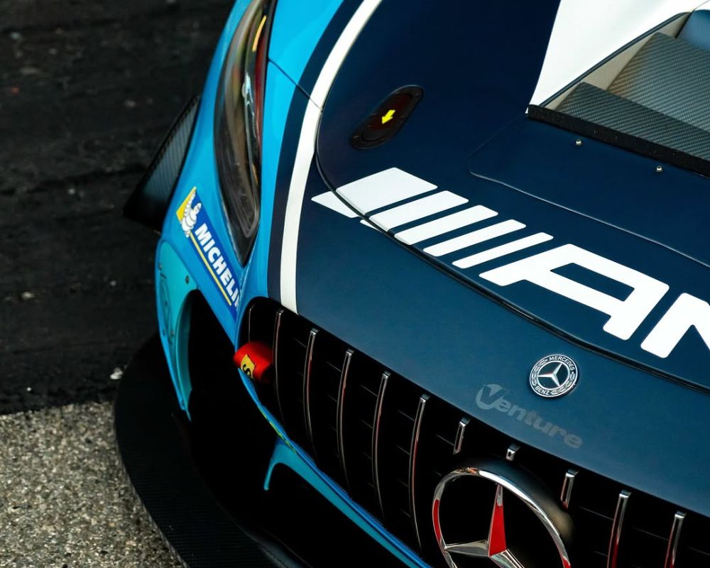 Mercedes AMG GT3 race car displayed in a dynamic pose, showcasing its sleek design and racing features.