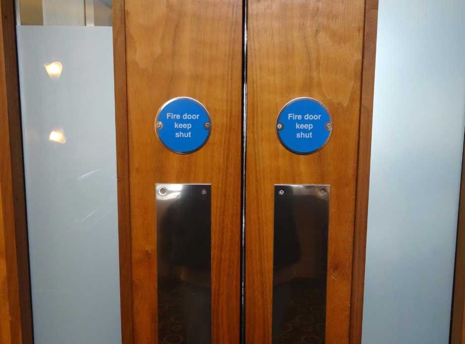 Two doors featuring blue signs, indicating different rooms or areas.