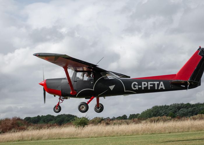 An Aeroplane wrapped in dark grey and red, at London Oxford Airport, Kidlington, Oxfordshire