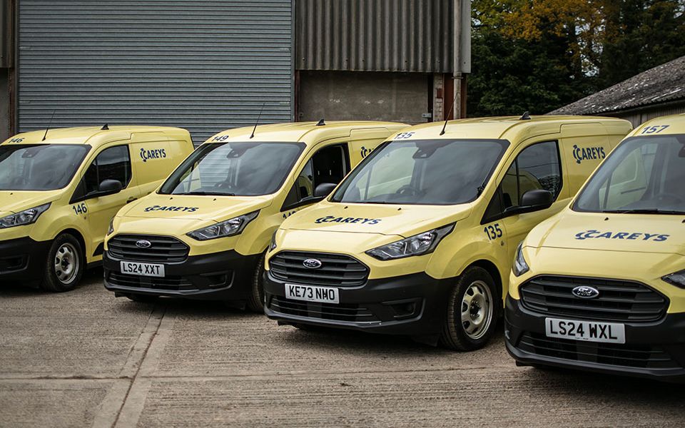 a van wrapped in yellow with logo