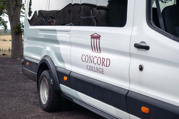 A Concord College van parked outside, featuring the college logo and a clean, modern design. 