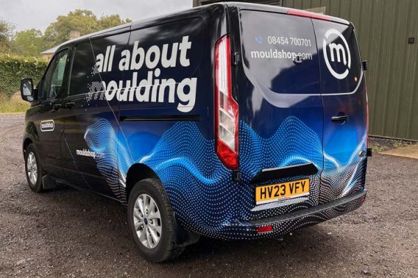  A van with the text "All About moulding" clearly visible on its side.