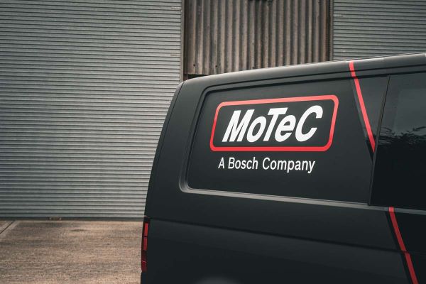 Motec logo design featuring a modern, stylized font with a sleek, dynamic appearance in a bold color scheme.  