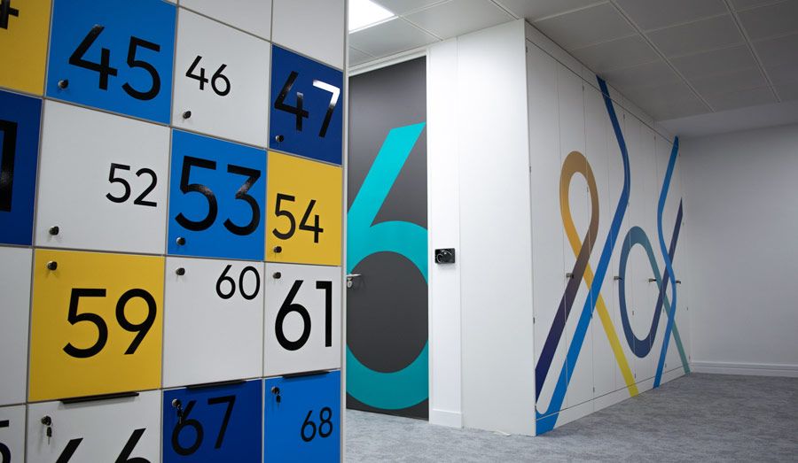A contemporary office space featuring vibrant blue and yellow walls, creating a dynamic and inviting work environment.