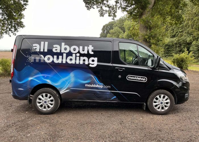 A John Deer tractor from Wallingford, Oxfordshire, wrapped in vibrant pink with green lifting arms